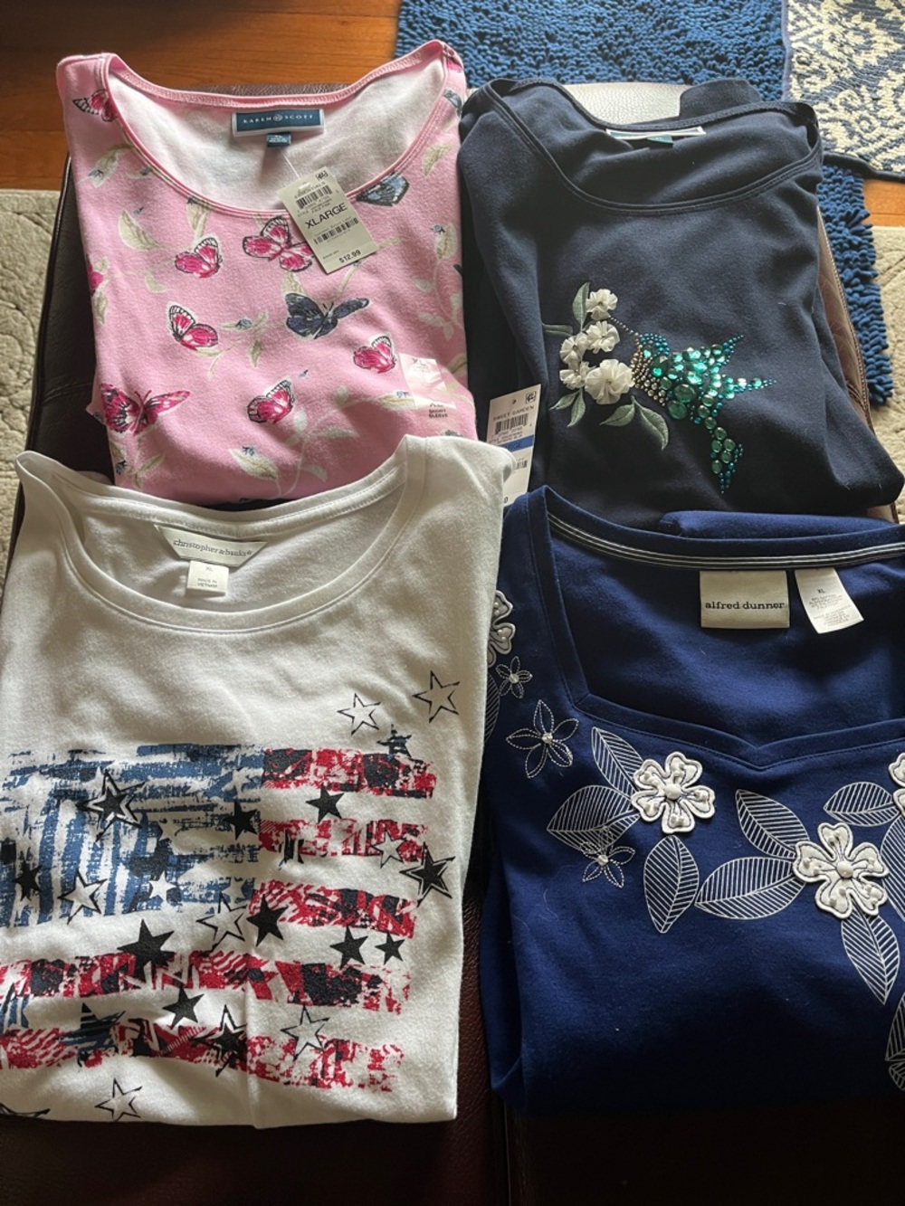 Women’s tops. You get all four. Two are new with tags. All extra large.